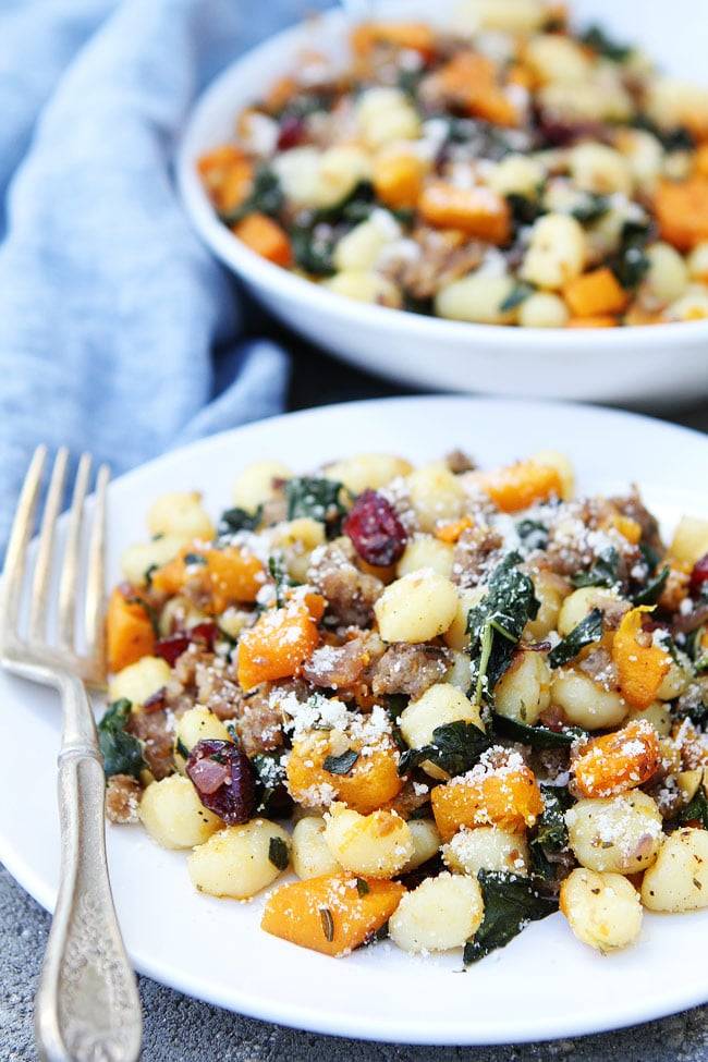 Gnocchi tossed with butternut squash, Italian sausage and cranberries on a light sauce served on a plate