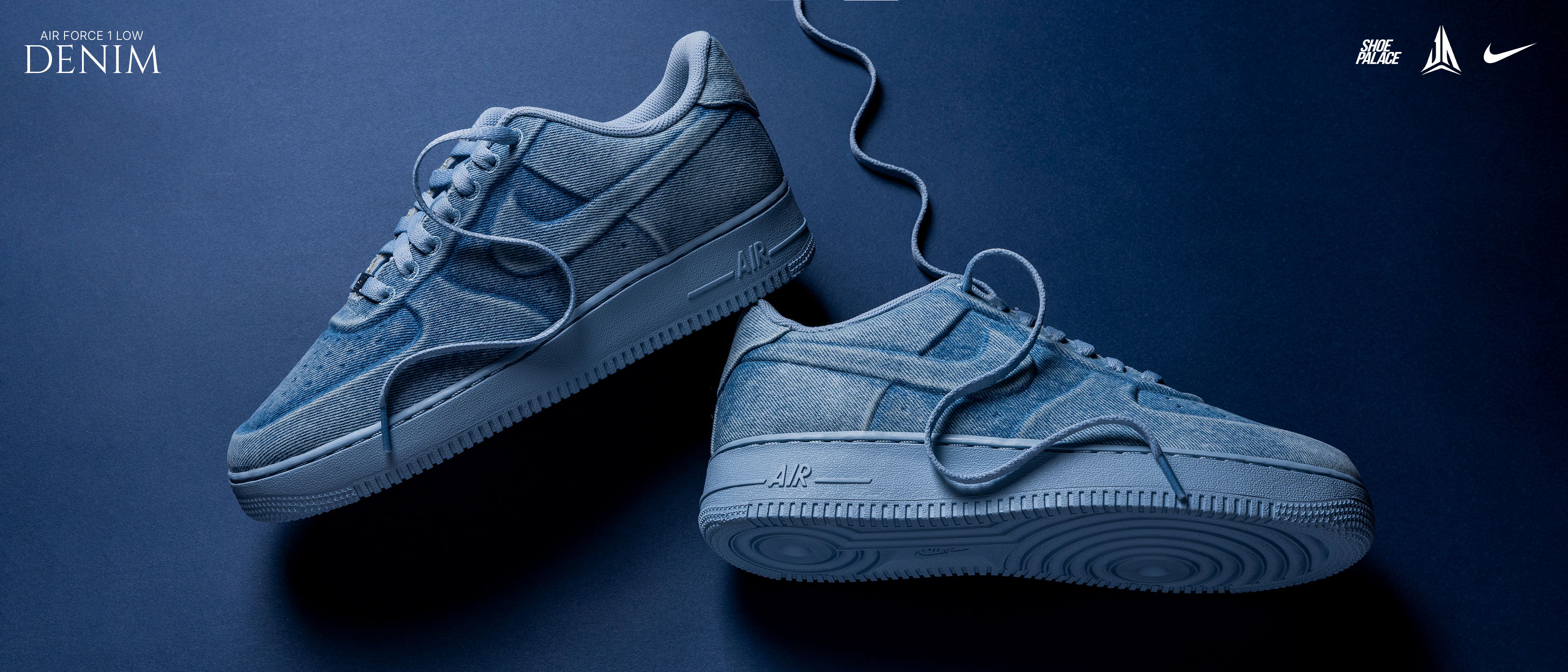 A pair of blue sneakers on a dark background.