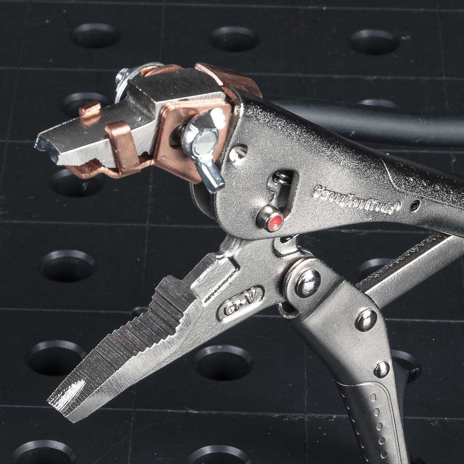 A close-up of a metal clamp tool with a textured handle.