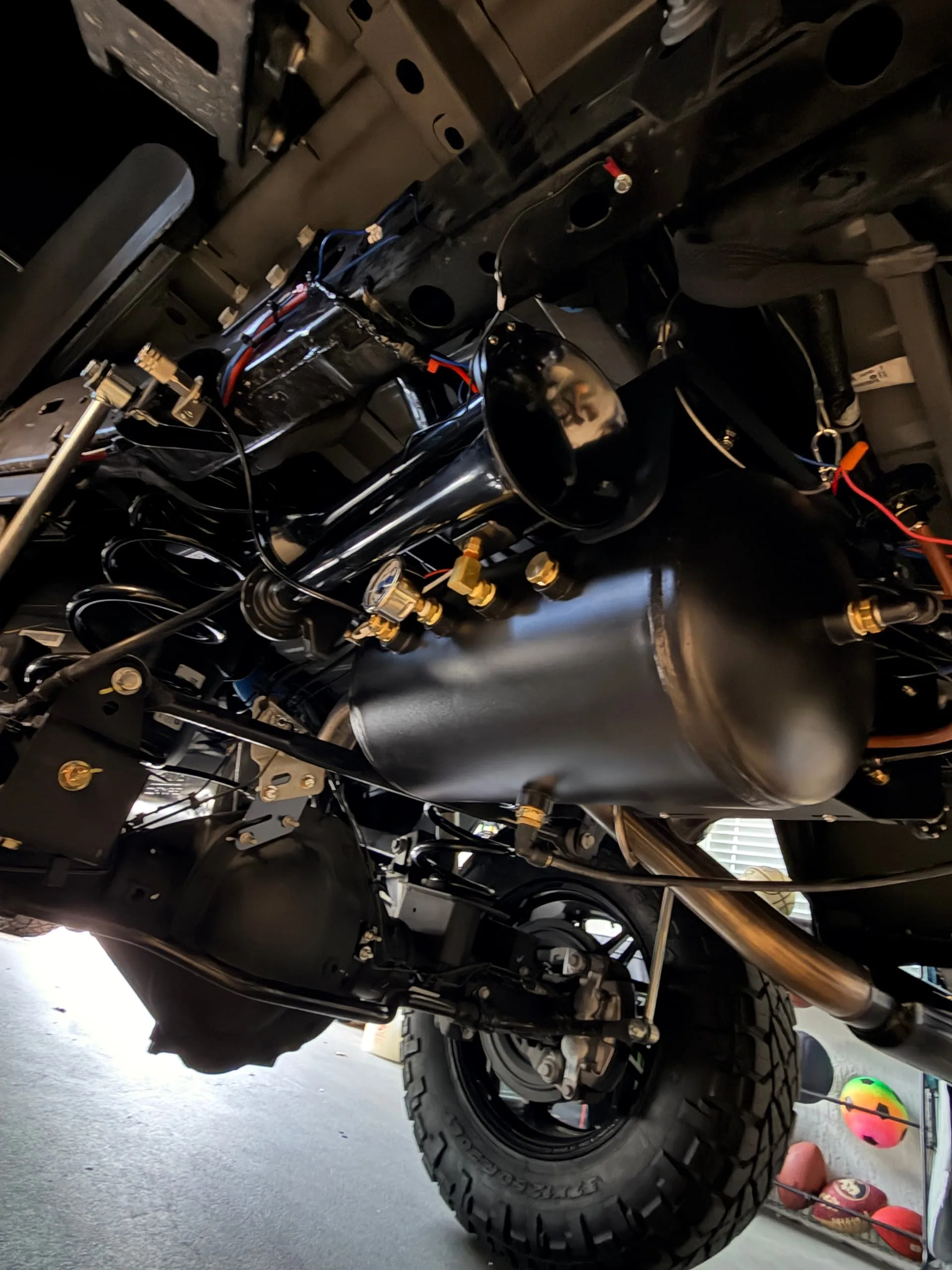 Michael's 2026 Dodge RAM 2500 train horn installation detail with Stealth Spare Tire Delete Kit photo 3