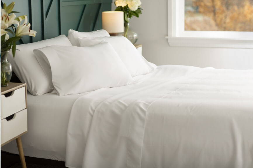 white bamboo bed sheets on a bed
