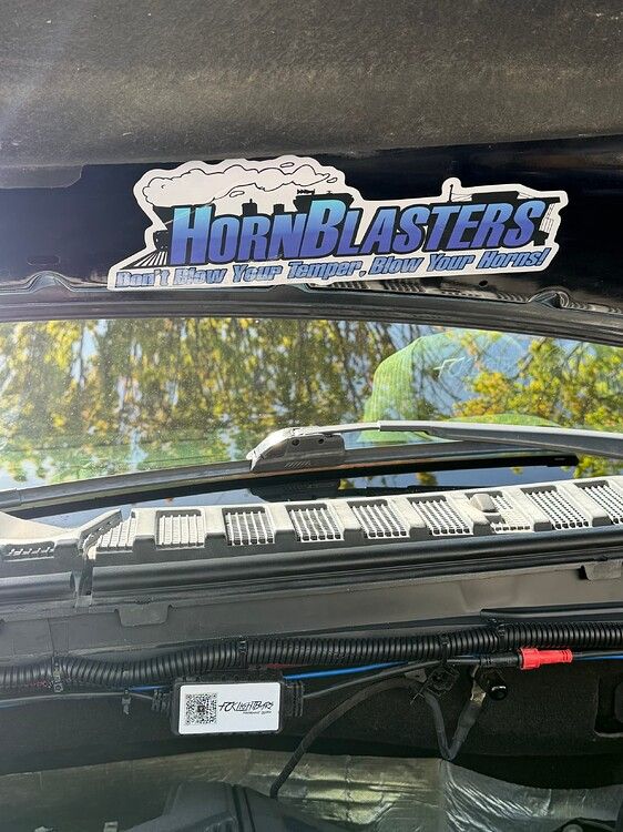 Under-hood view HornBlasters sticker and aftermarket wiring harness for Stealth Spare Tire Delete on Troy's 2018 Ford Expedition gallery photo 9