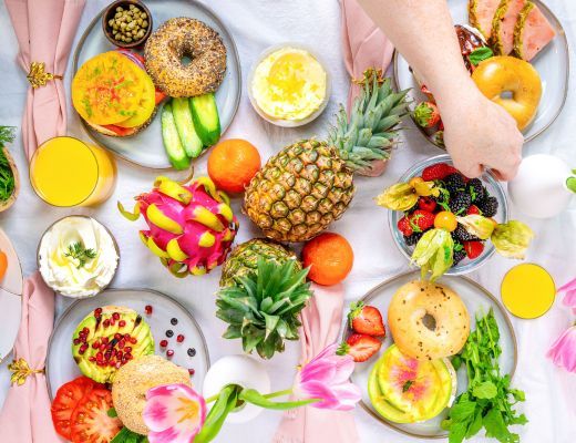 Colorful assortment of fruits and pastries on a table.