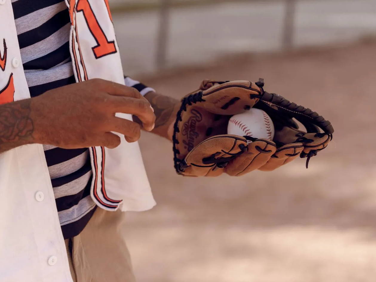 male model holding baseball in glove
