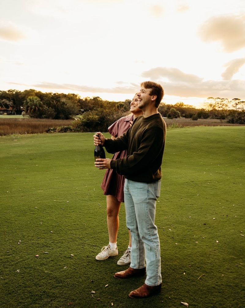 engaged couple celebrating with champagne
