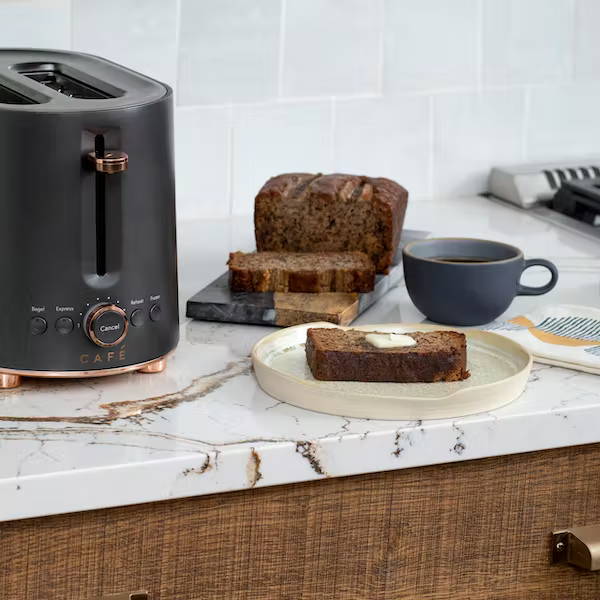 matte black toaster next to slice of toasted banana bread