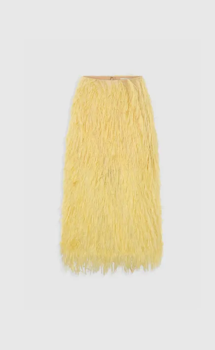 Yellow fringe skirt on a plain background.