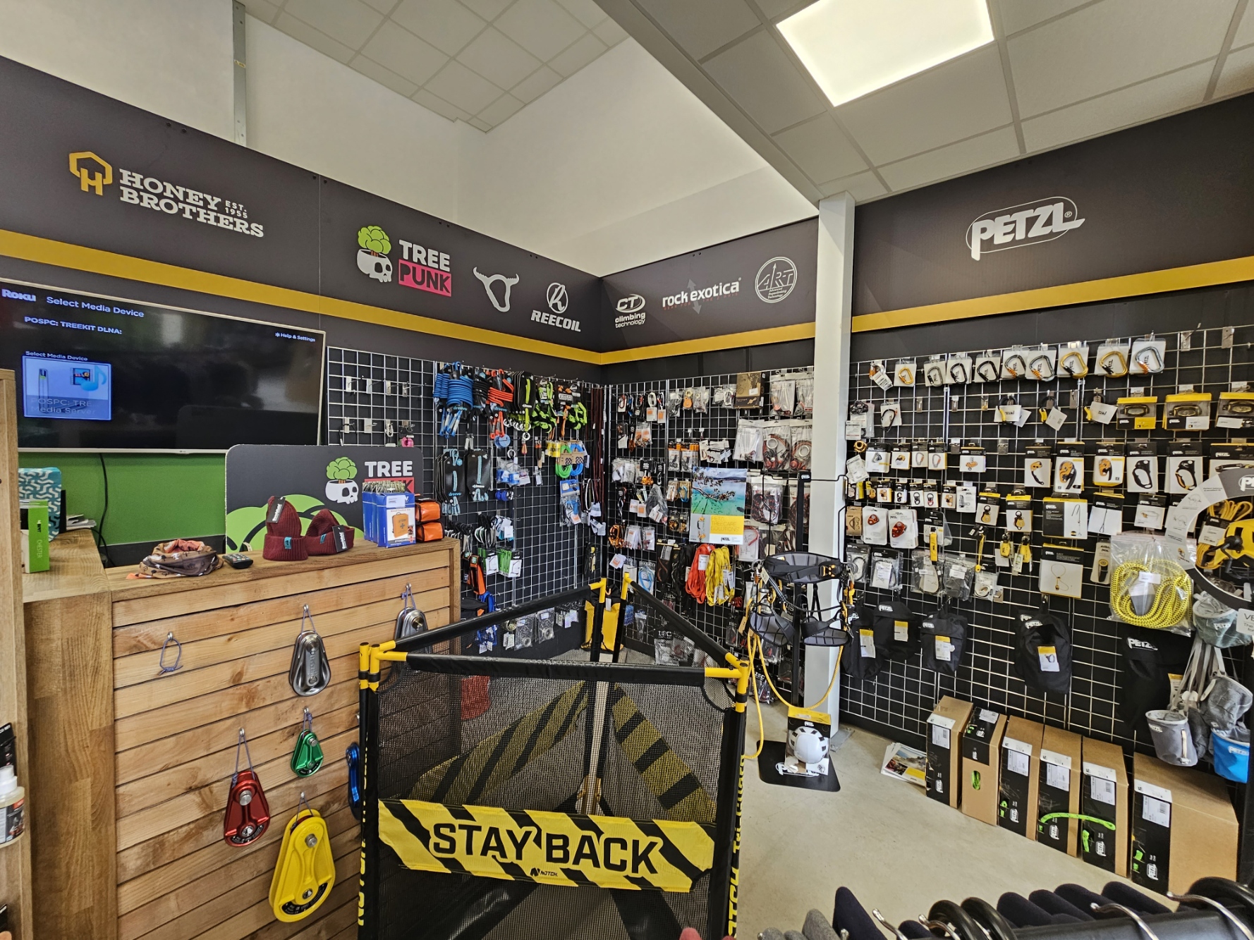 Retail space showcasing climbing gear and equipment on display walls.
