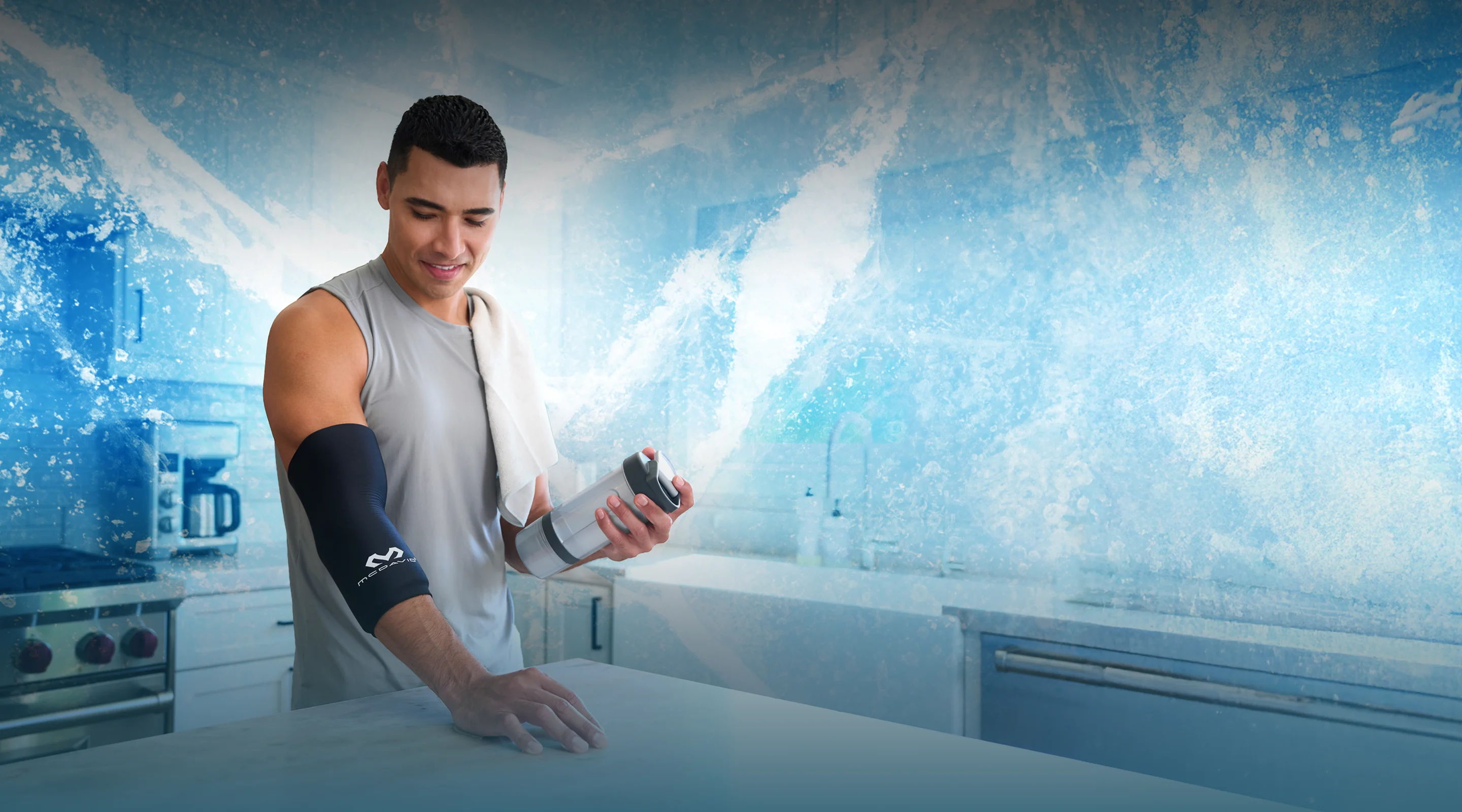 Person holding a water bottle in a modern kitchen with a blue background.