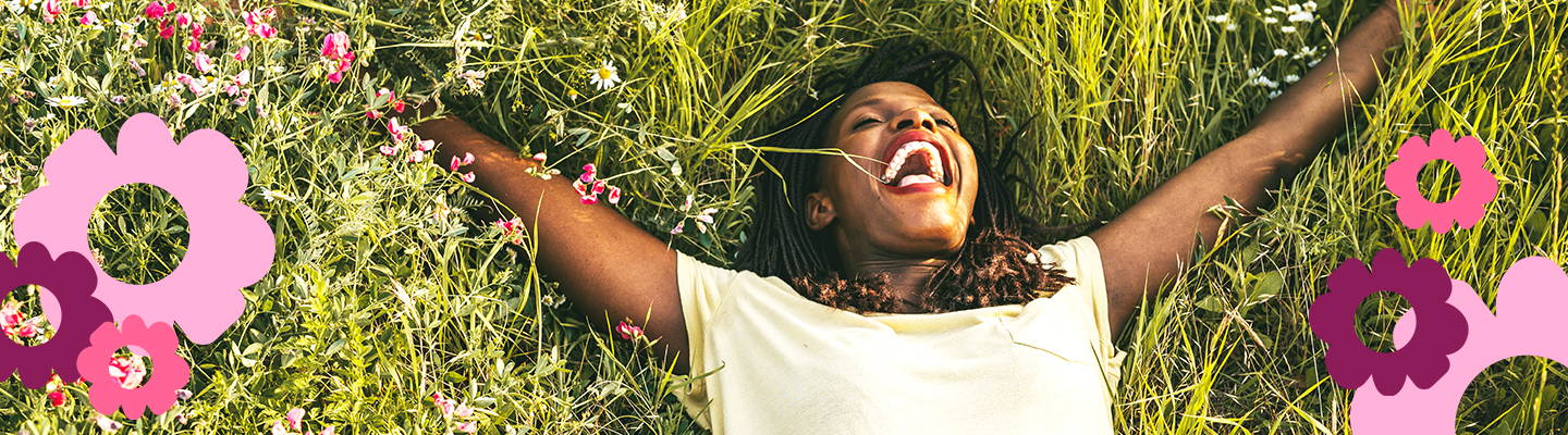 Lady laying in grass laughing out loud