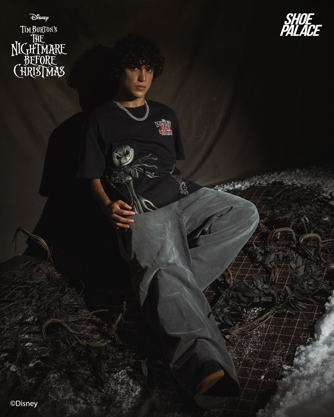 Person sitting in dark outfit, themed around 