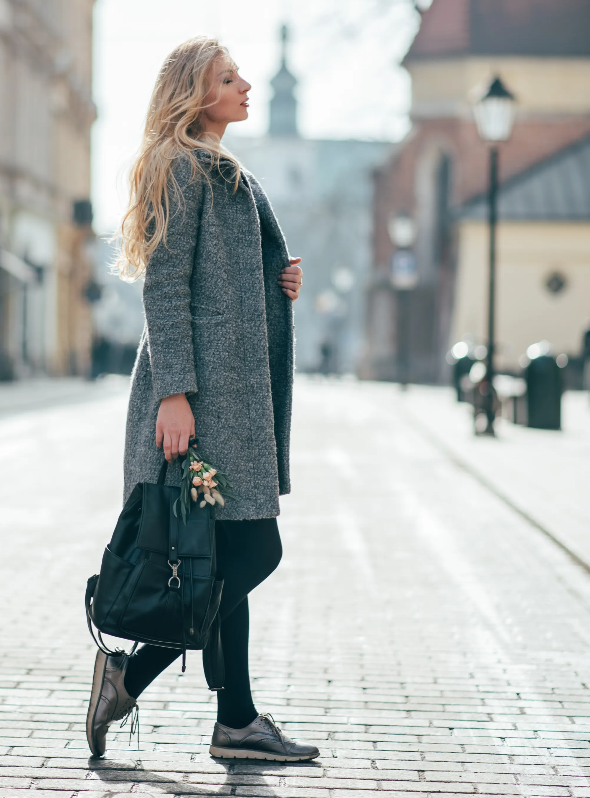 Stylish woman walking in street