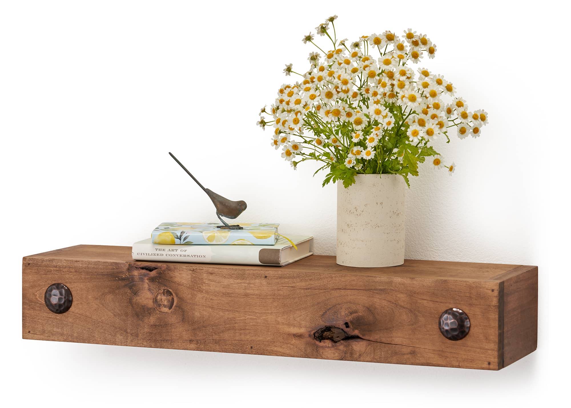 books and a small flower vase on the wood floating shelf 