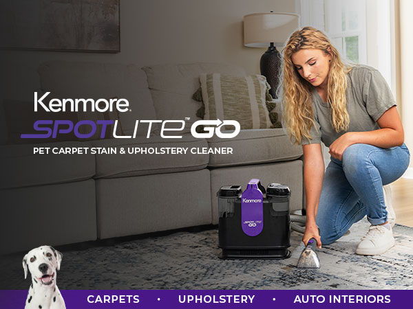 Woman cleaning carpet with Kenmore Spot Lite Go cleaner in living room.