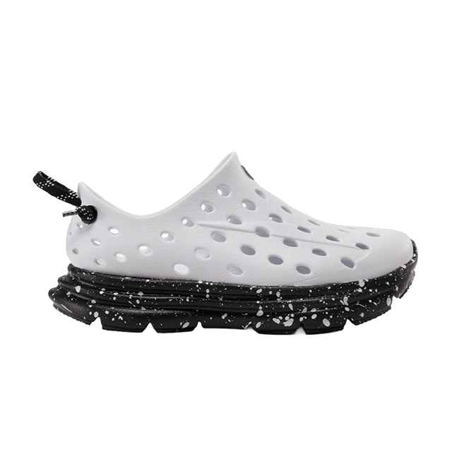 White perforated slip-on shoe with a black speckled sole.