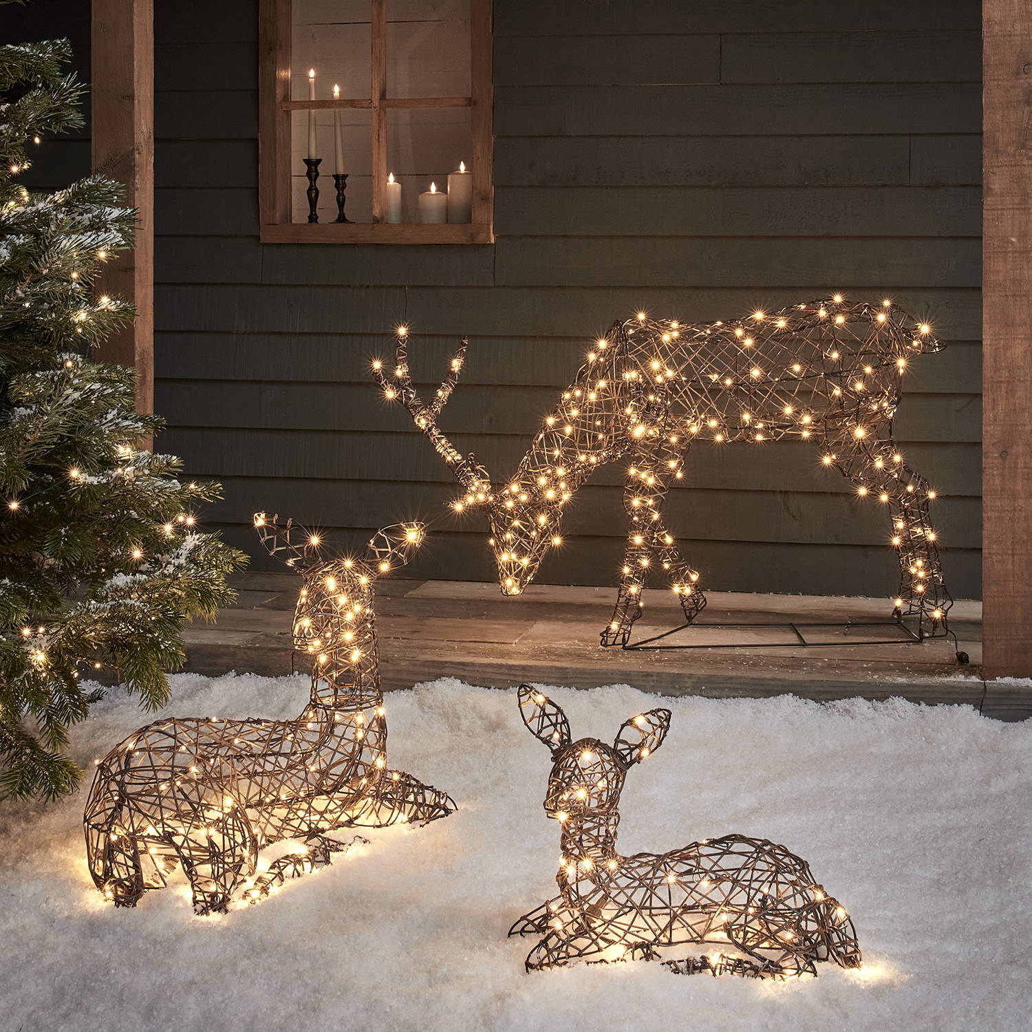 Set of 3 Studley family reindeer in an outdoor snowy cottage setting.