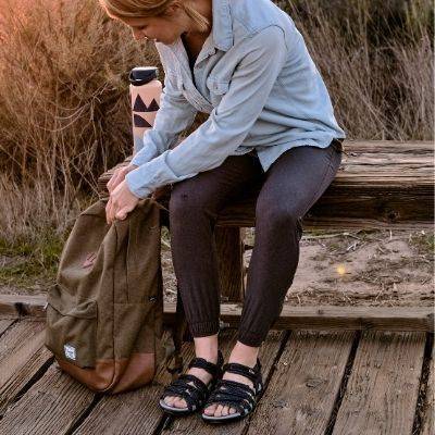 woman wearing acadia hiking sandals on bench