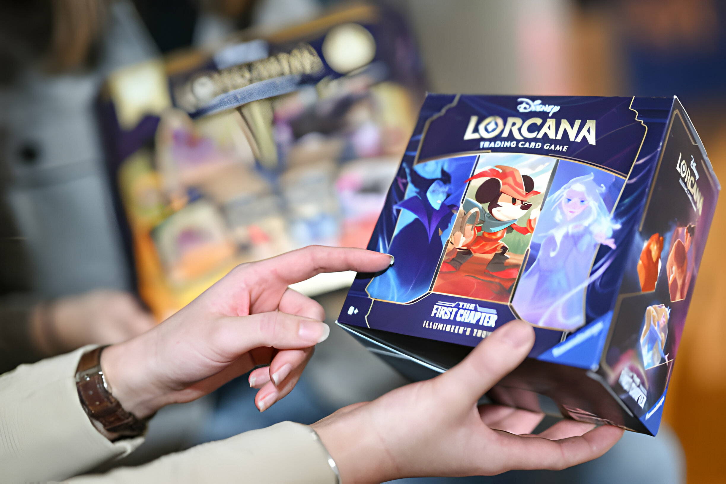 Hand holding disney lorcana set box