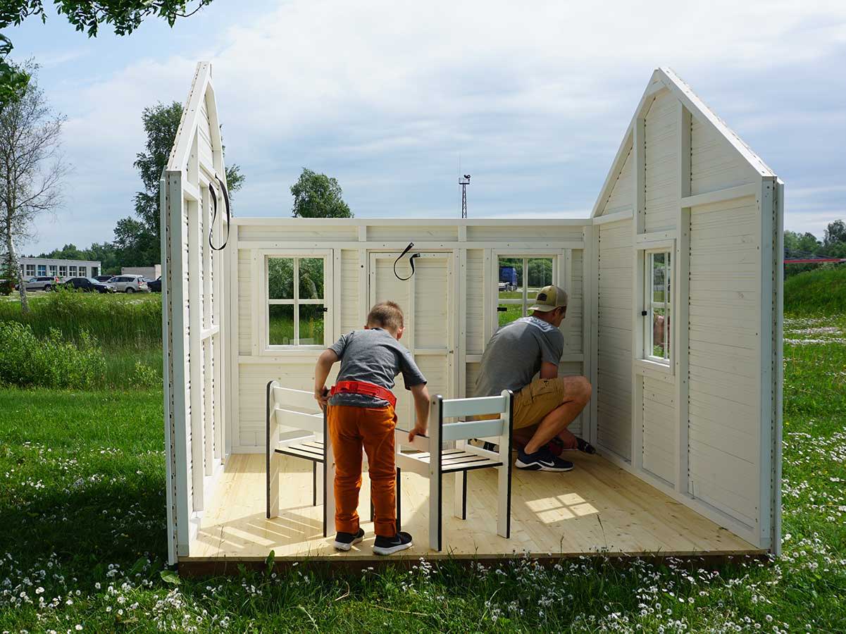Father and son set up Kids Wooden Playhouse Arctic Nario by WholeWoodPlayhouses