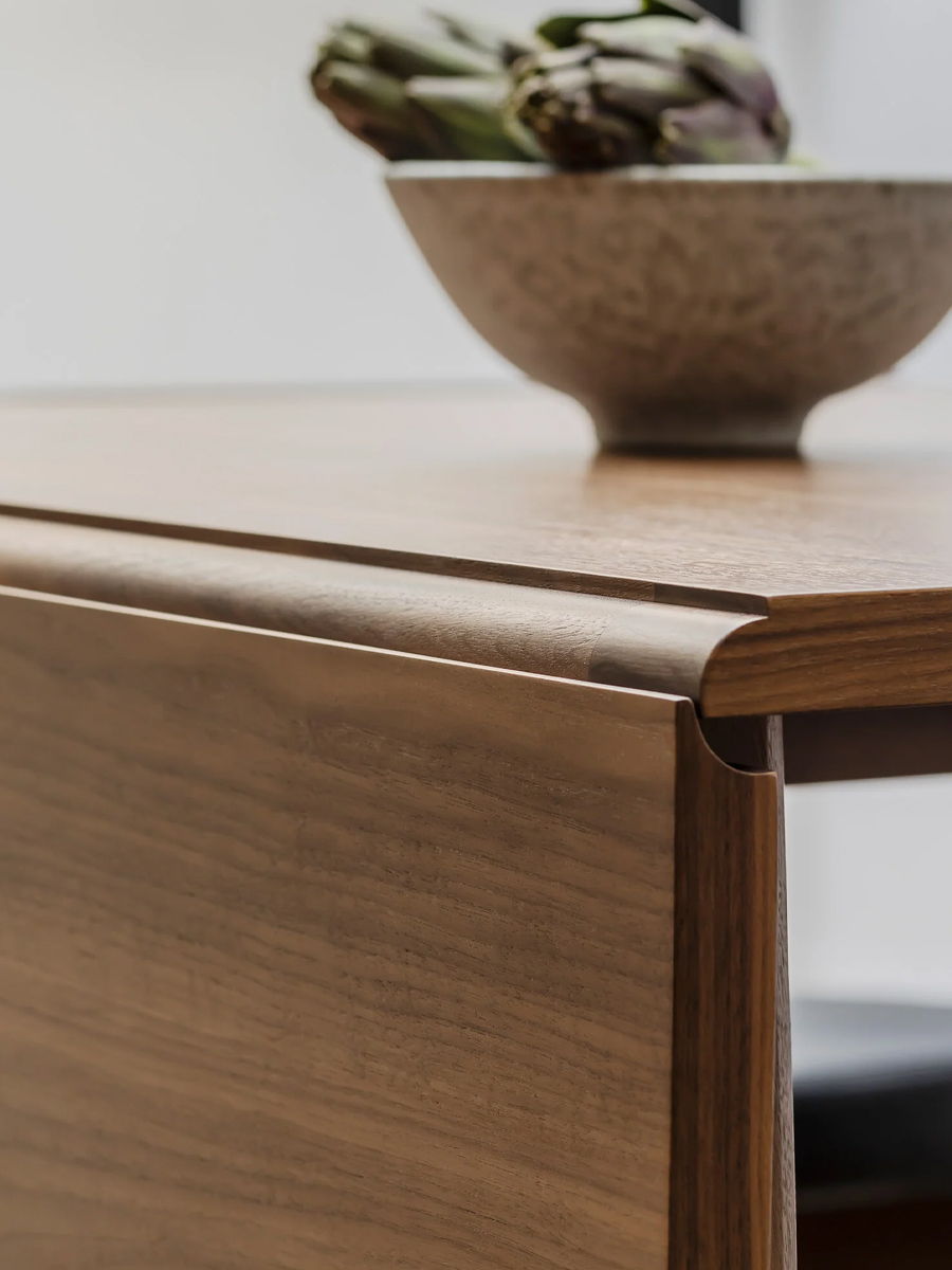 Close-up of a wooden Marlow drop leaf table by Case with a bowl on top.
