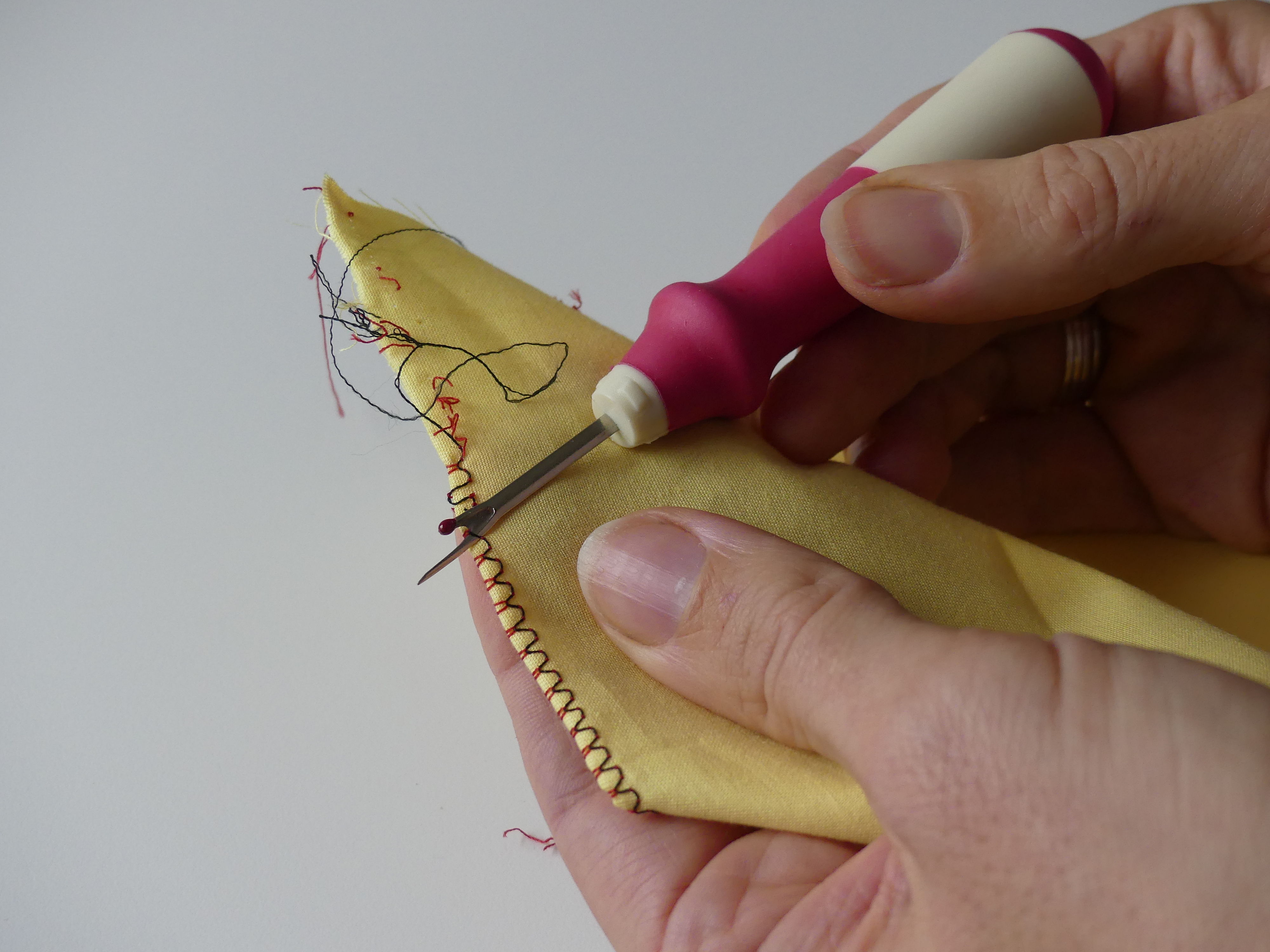 using the madam sew deluxe seam ripper on yellow fabric