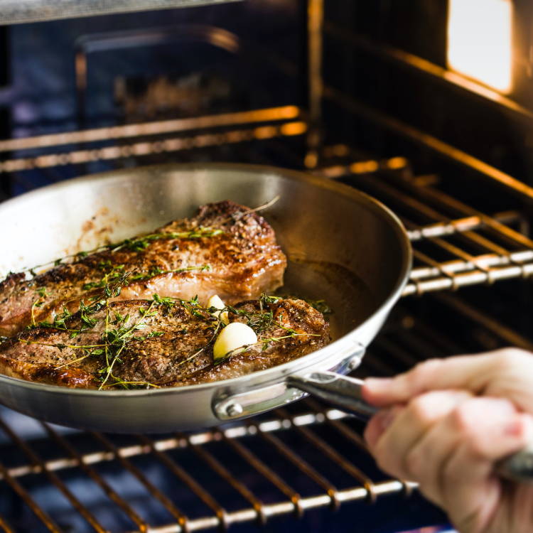 The Misen Stainless Skillet can go from stove to oven & is perfect for a variety of dishes, including rosemary garlic steak.