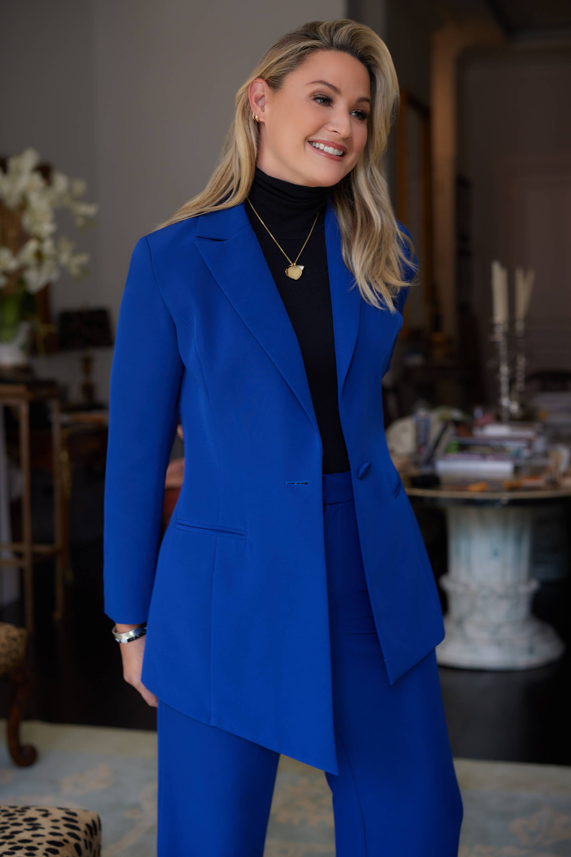 Sunny wearing blue silk lined suit with black turtleneck in New York City by Ala von Auersperg
