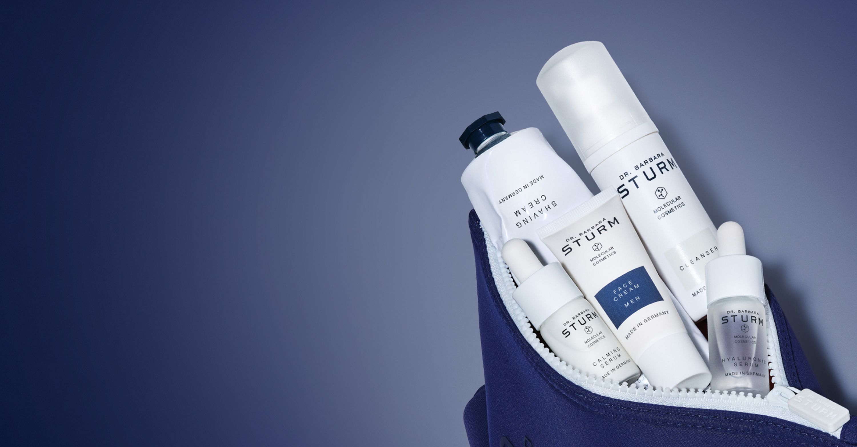 Skincare products in a navy cosmetic bag on a blue background.