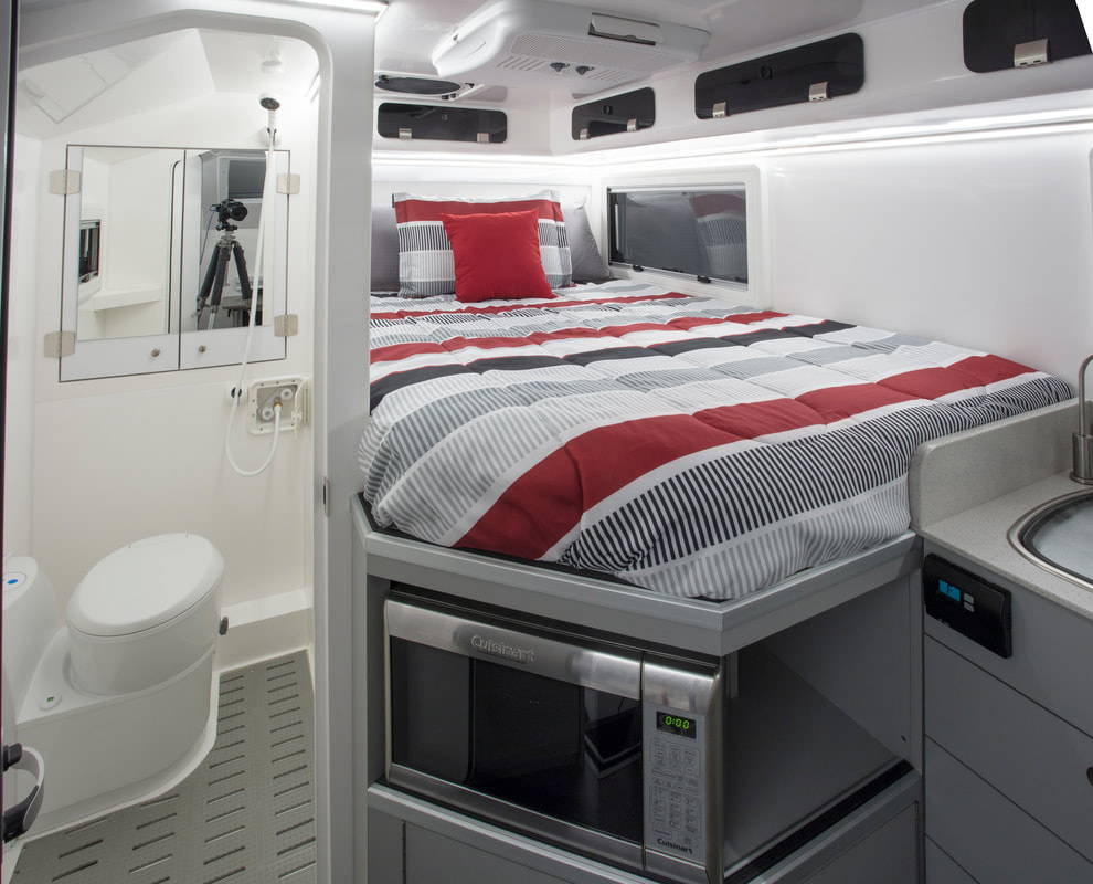 Interior, showcasing bed, microwave and toilet