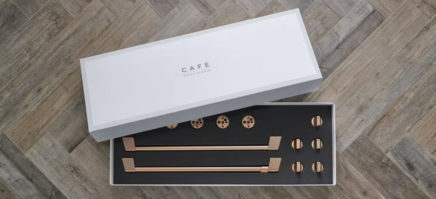 Box containing decorative hardware with gold accents on a black base.
