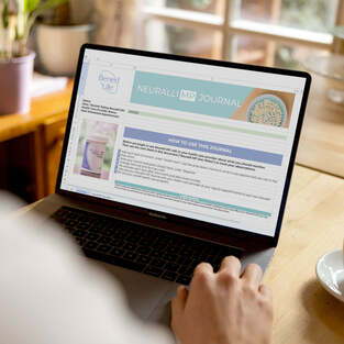 Person using a laptop with a website displayed on the screen.
