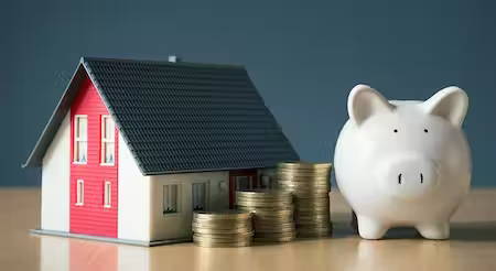 Photo of house and piggy bank showing money savings