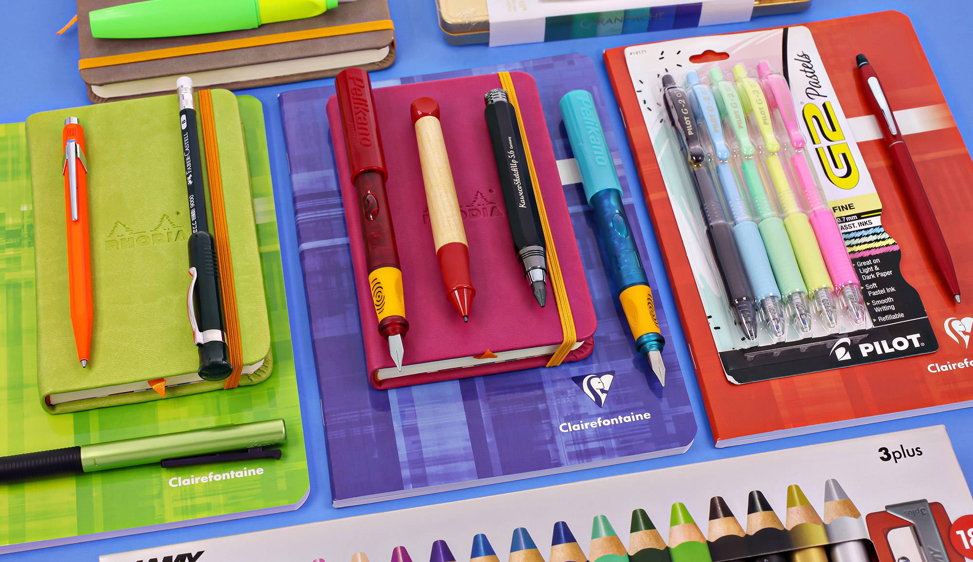 All of our favorite pens laid out over notebooks