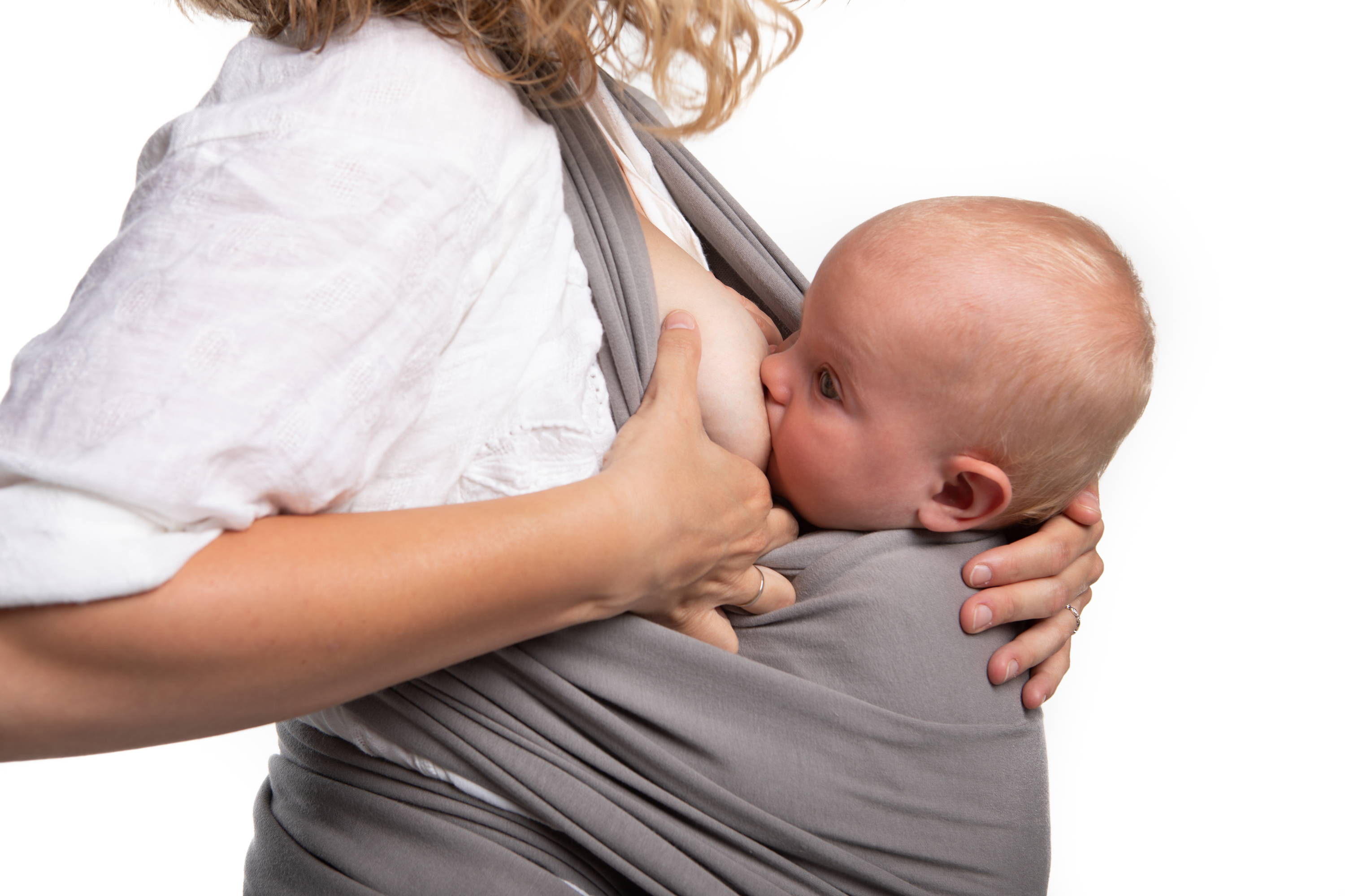Baby breastfeeding in a gray cotton wrap with mom holding breast