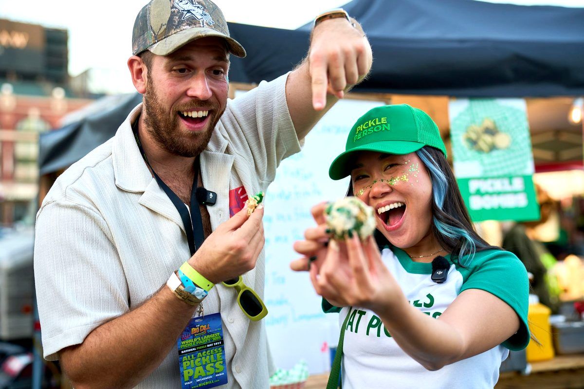 Foodbeast creators trying Pickle Bombs at a food vendor at The Big Dill pickle festival at Texas Live! in Arlington Texas