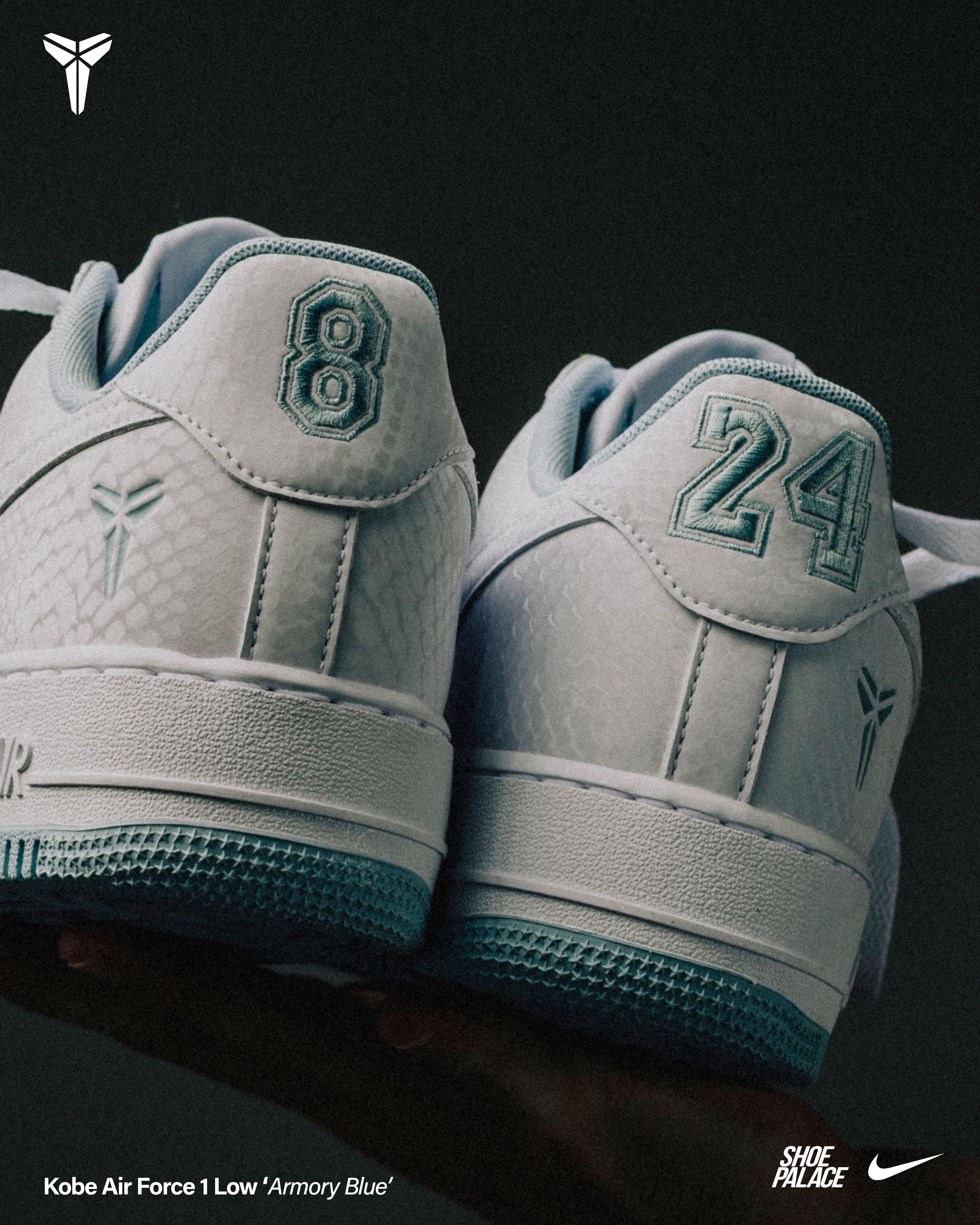 White Kobe sneakers with numbers 8 and 24 on the heels.