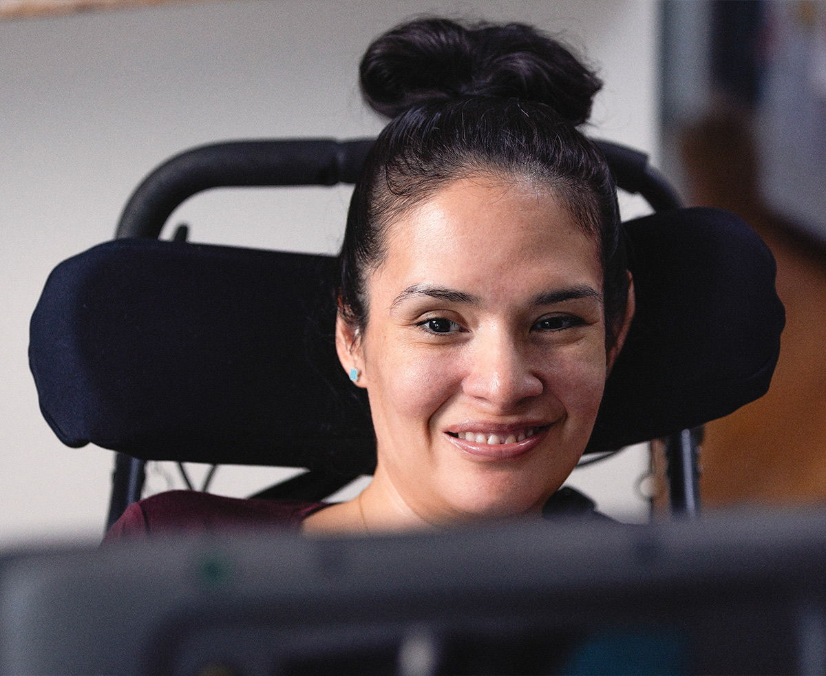 Woman using voice banking with a Tobii Dynavox AAC device to communicate
