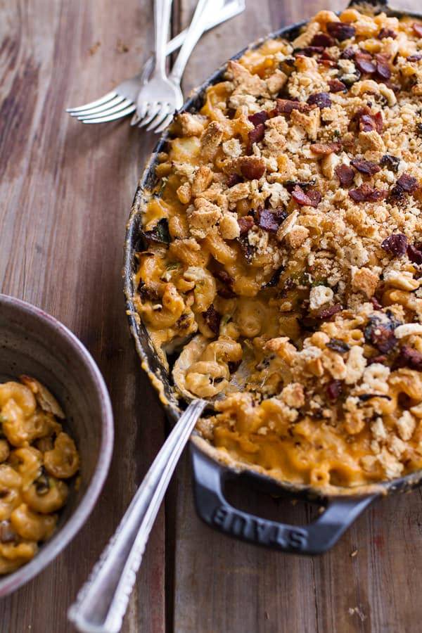 Mac and cheese made with cavatappi pasta, butternut squash, brussels sprouts and topped with crumbled crackers prepared in a baking dish