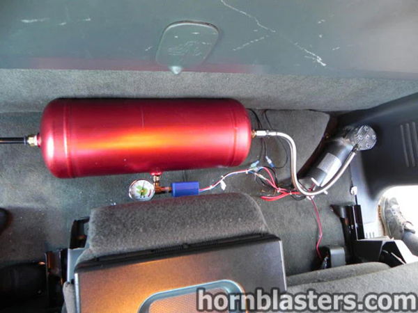 Wide interior view showing the red air tank mounted behind the seats in Thomas's 2005 Chevrolet Silverado 1500, install photo 9