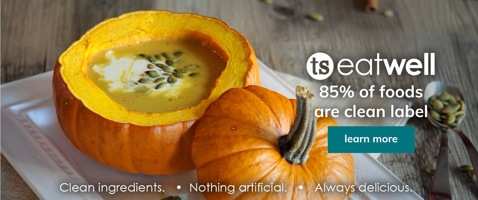 Pumpkin soup served in a hollowed pumpkin with the text “TS EatWell, 85% of foods are clean label” and a “Learn more” button.