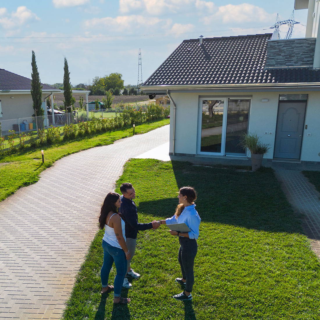 security camera POV of real estate agent shaking hands with couple