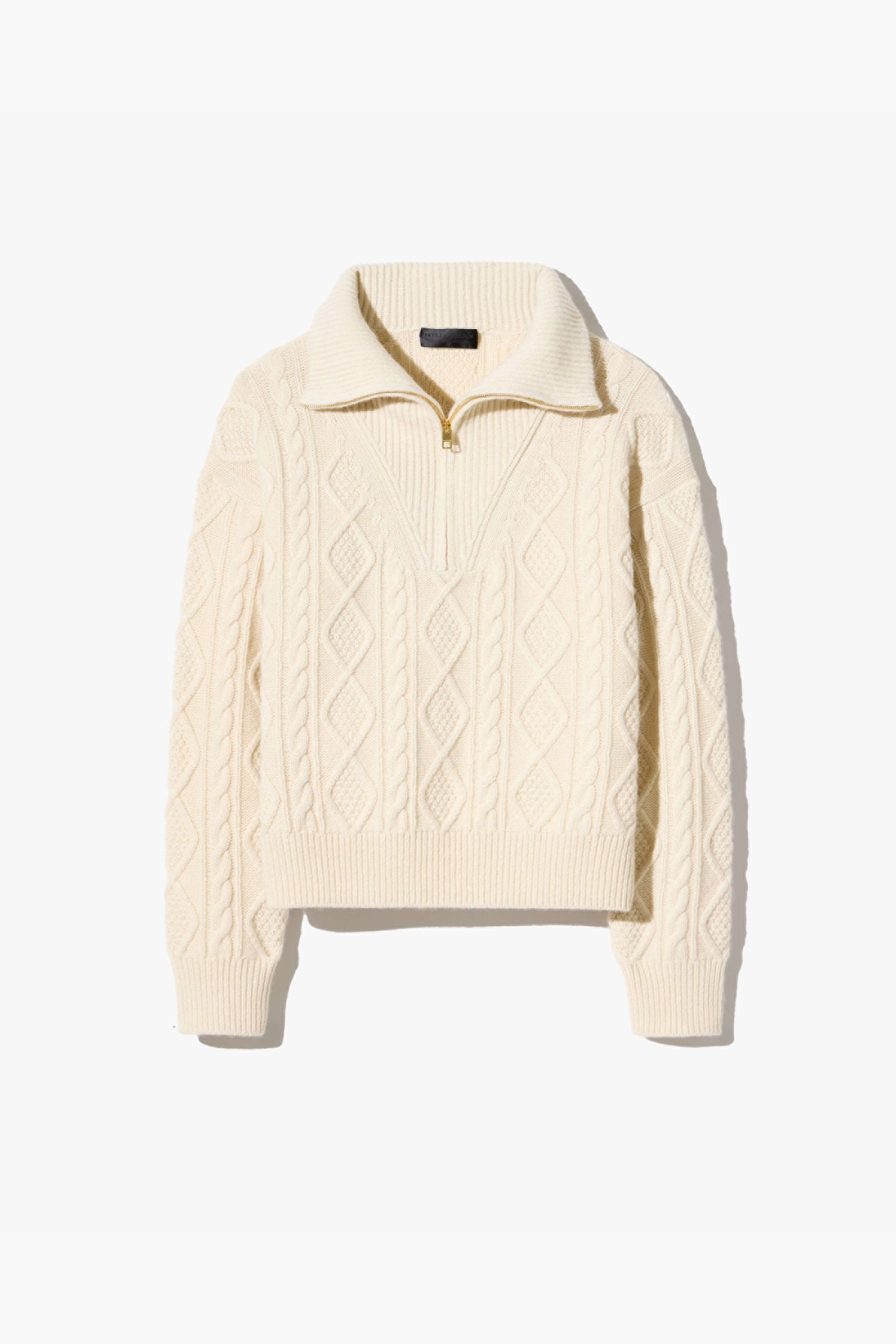 Cream-colored cable knit sweater with a quarter zip collar.