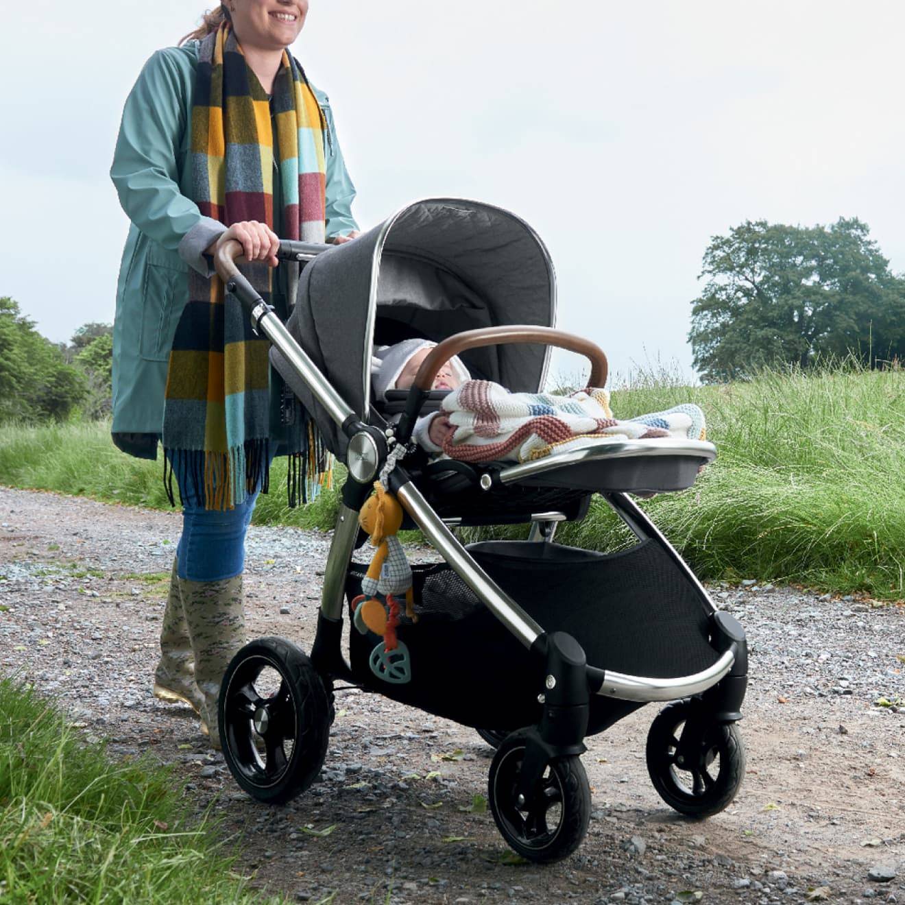 Mother pushing her pushchair with baby