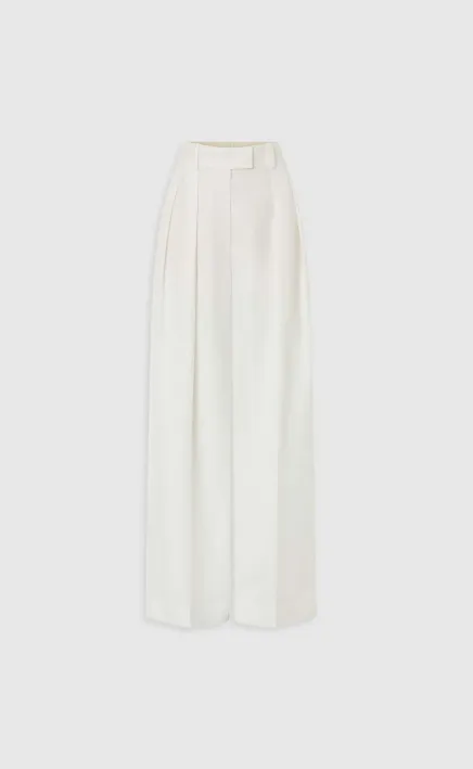 White high-waisted pleated wide-leg pants on a neutral background.