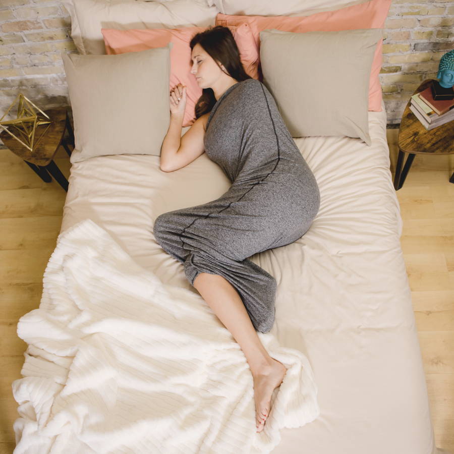image of woman in sleep pod sleeping in bed