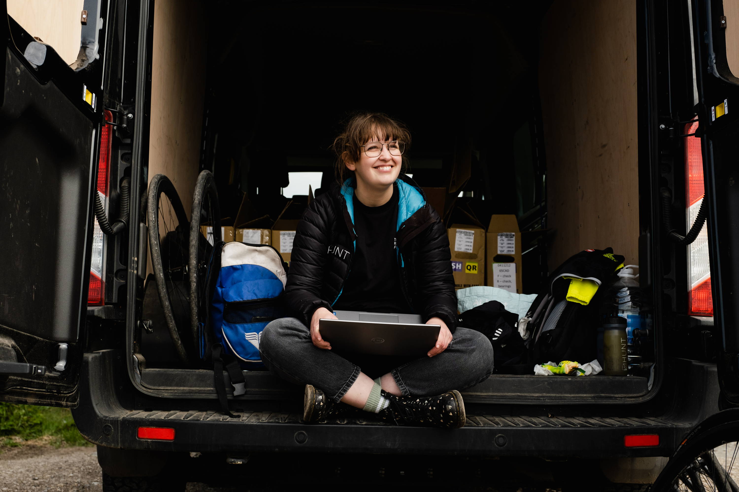 Niamh smiling while sitting in the back of a HUNT Van