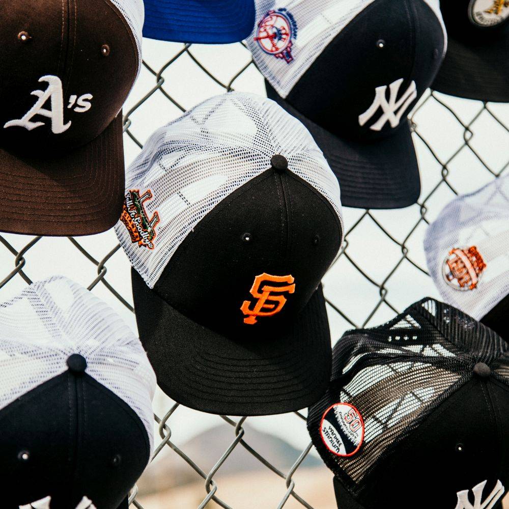 sp x '47 brand trucker hats hung on fence 2
