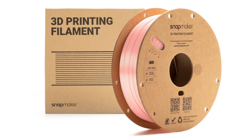 3D printing filament spool next to its packaging.
