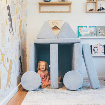 Toddler playing in kids play couch cubby
