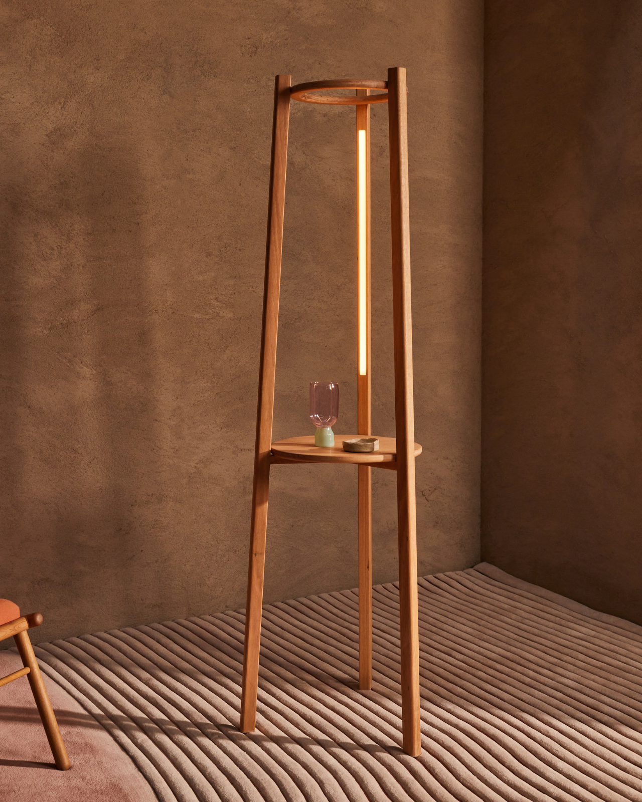 Tripod Timber Floor Lamp | Boyds with a warm glow against a brown wall victorian ash timber